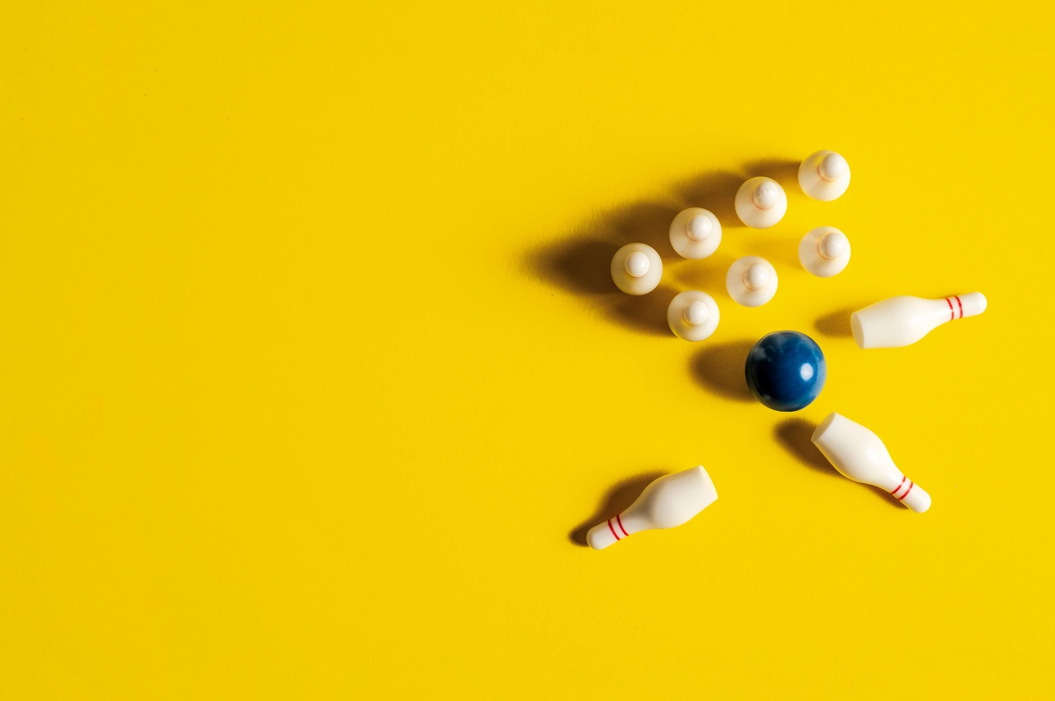 Bowling pins and ball on a bright background with copy space