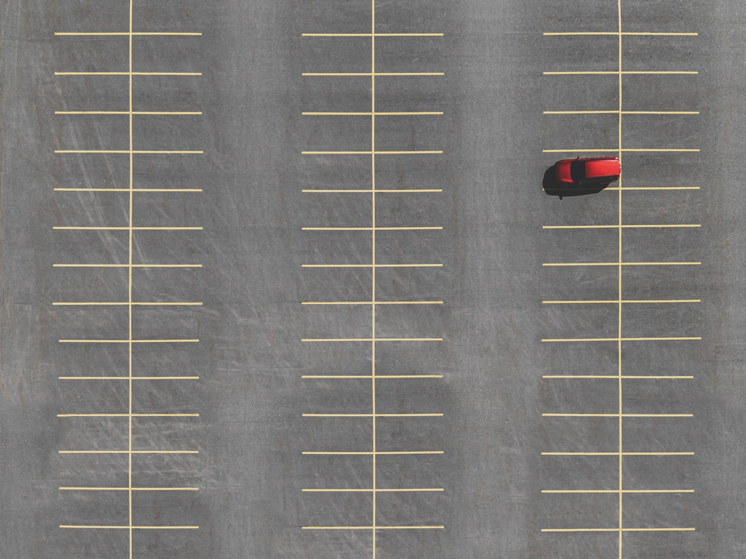 Aerial view of a parking lot with clearly marked spaces